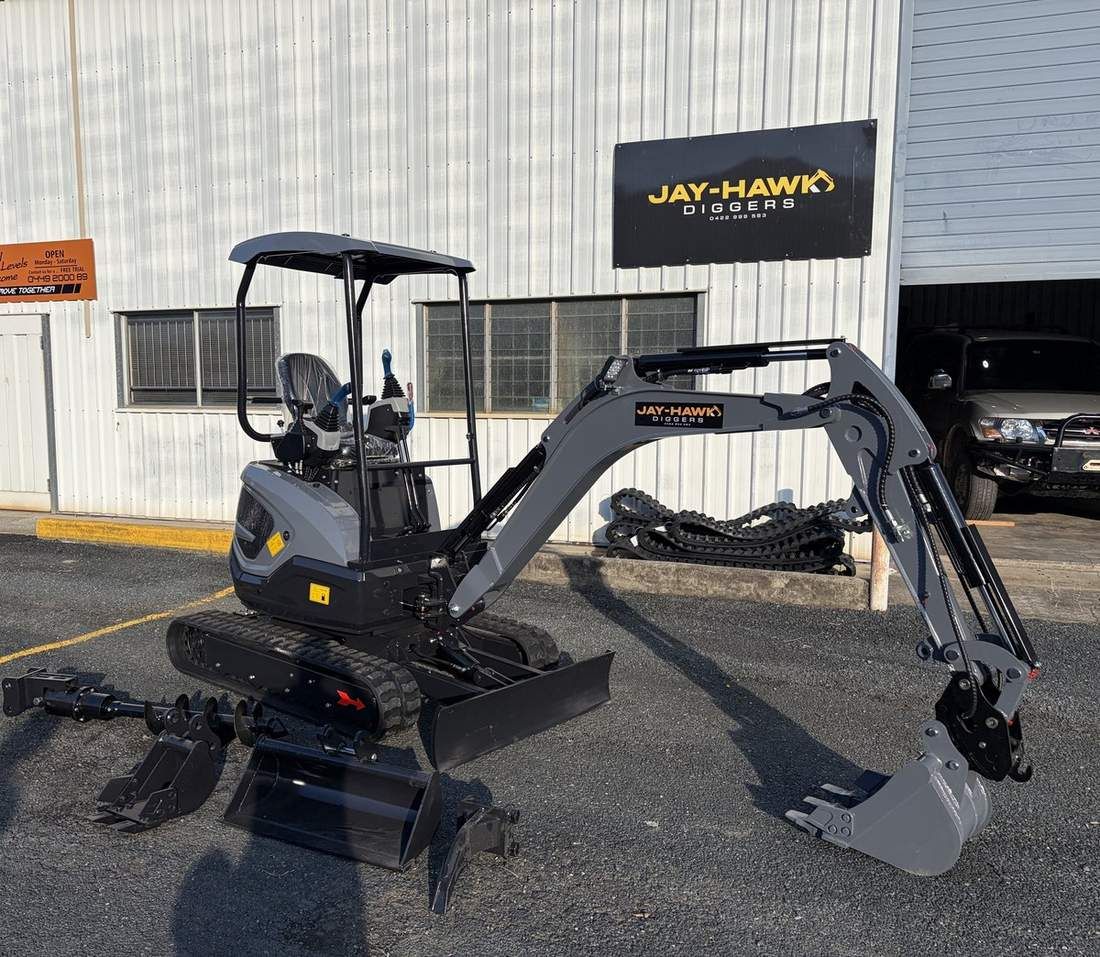 JHM20 mini excavator with full attachment set laid out at the Jay-Hawk Diggers yard